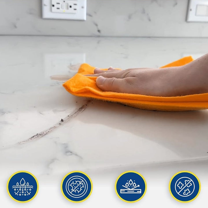 Hand holding a durable non-woven cleaning cloth, demonstrating its flexibility for household use