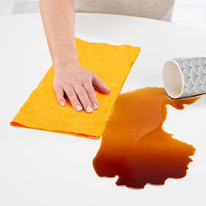 Absorbent non-woven towel wiping a kitchen counter, showing its effectiveness