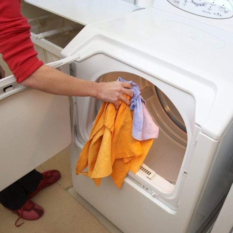 Lint-free cleaning cloth used to polish a glass surface, showcasing its streak-free finish