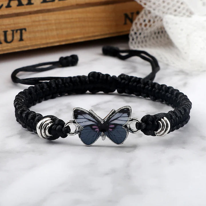 Unisex adjustable woven cotton bracelet with a delicate silver butterfly charm, perfect friendship jewelry.