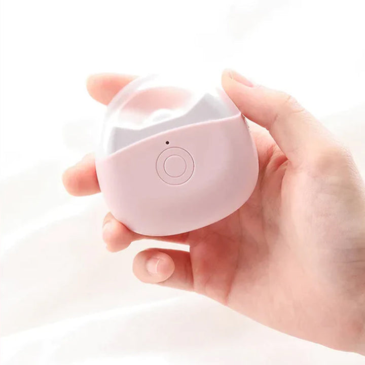 Side view of the automatic nail clipper and its USB charging port, a convenient grooming gadget
