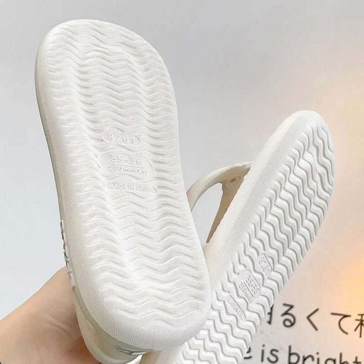 Someone putting on Unisex Beach Pool Slide Sandals, easy slip-on style, beach essential