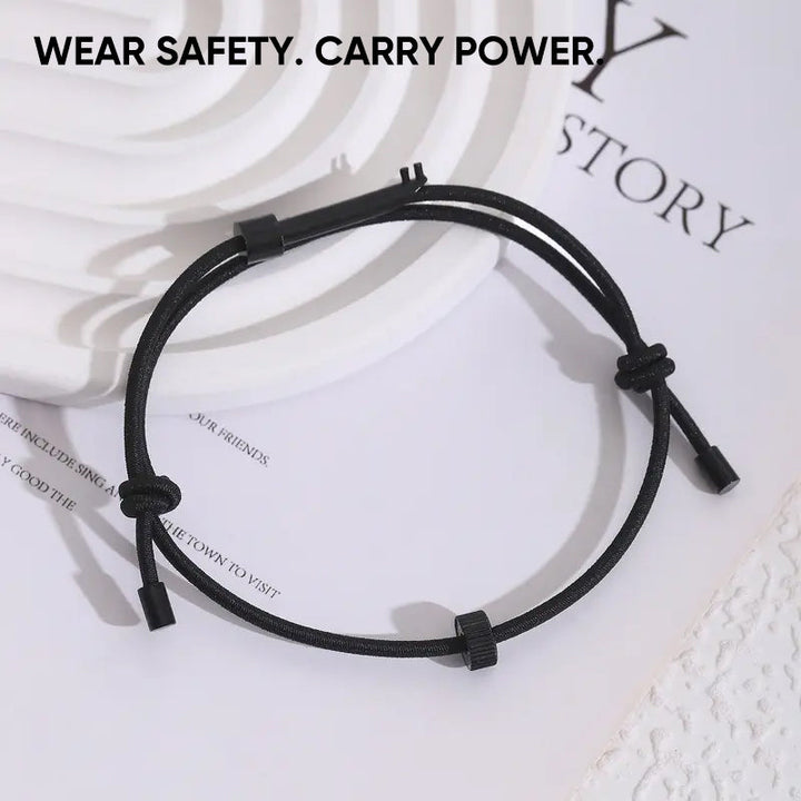 Hands demonstrating use of emergency window breaker bracelet for car glass breaking in emergency
