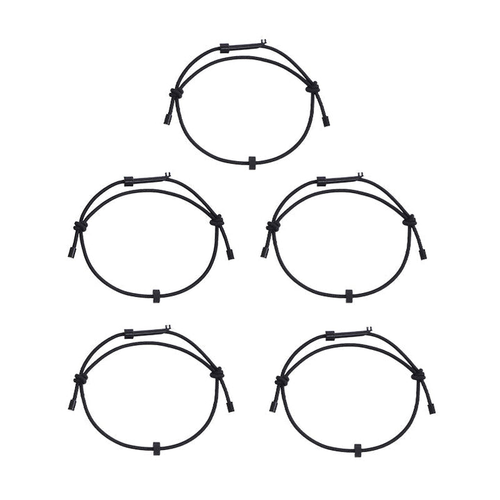 The emergency window breaker bracelet and key laid flat, showcasing its minimalist design