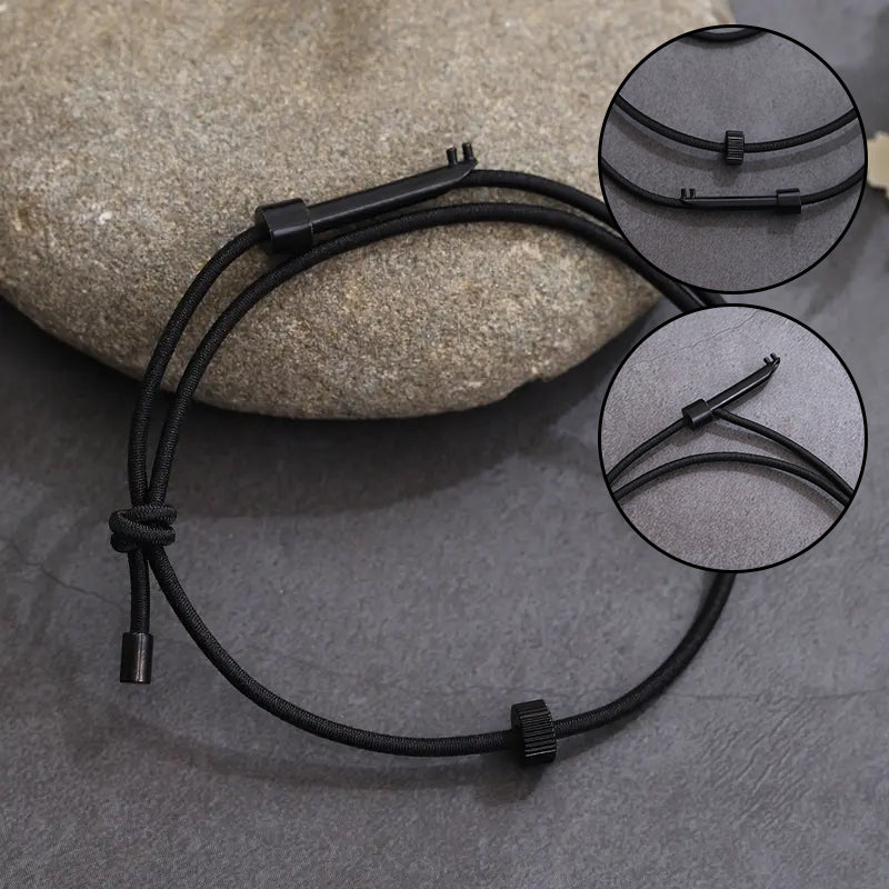 Close-up of window breaker tungsten carbide bead on a black tactical escape bracelet