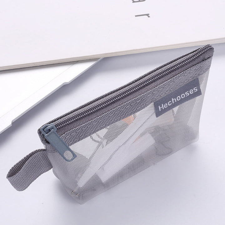 Small zippered mesh cosmetic bag for easy view and access to beauty products.