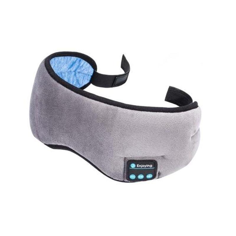 Person comfortably wearing a grey Bluetooth sleep mask, enjoying music or audio for sleep or meditation.