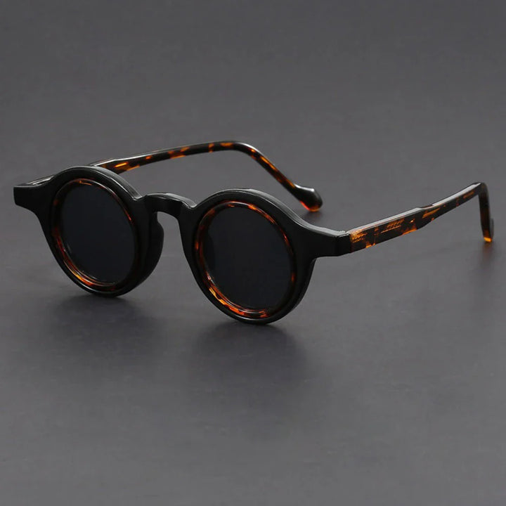 Fashionable unisex round sunglasses with thick frames, providing excellent UV protection for all-day wear.