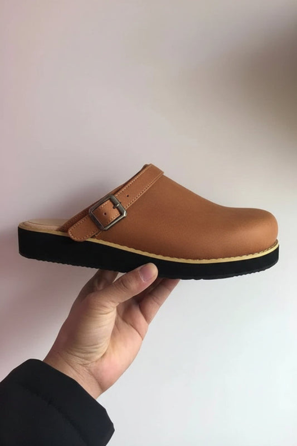Black work clogs, unisex slip-on style, providing all-day comfort and essential foot support. Durable daily footwear.