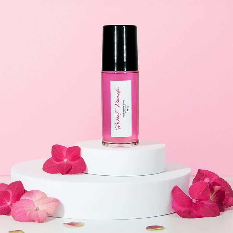 Captivating Roll-On Fragrance Oil on a vanity, ready for use as a luxurious peach and vanilla perfume.