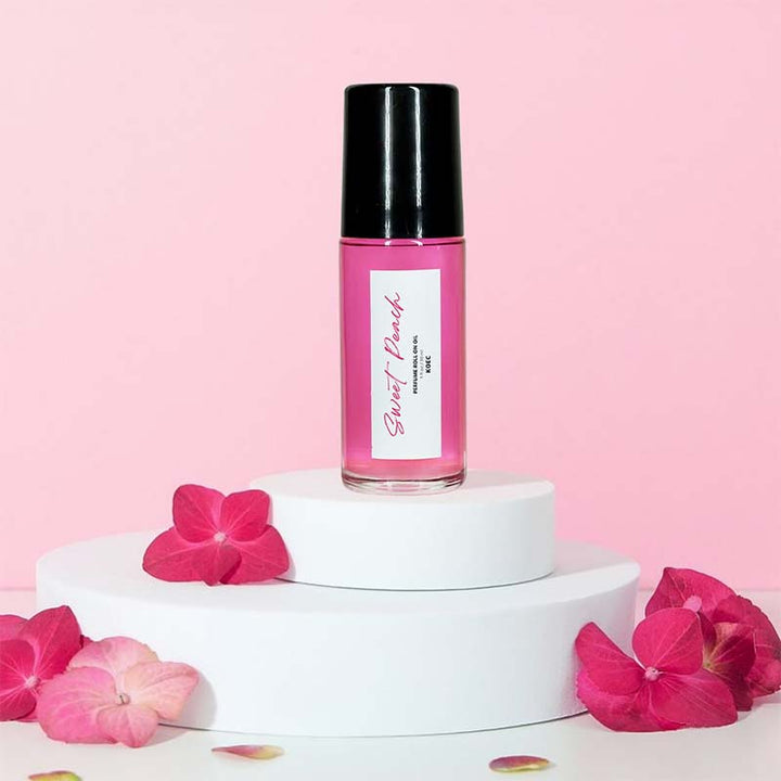 Captivating Roll-On Fragrance Oil on a vanity, ready for use as a luxurious peach and vanilla perfume.