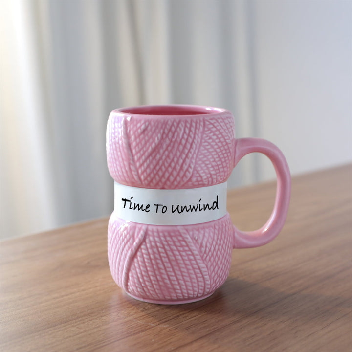 High-quality ceramic mug displaying a fun knitting yarn ball design, packaged for gifting.