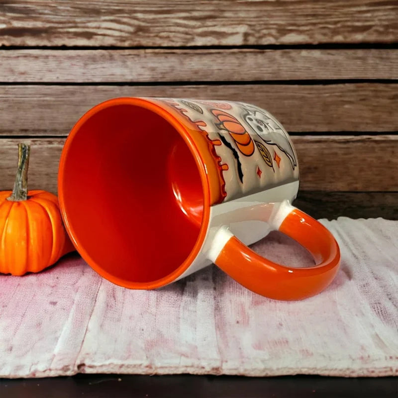 White ceramic coffee mug, unisex, shaped like a pumpkin with an adorable ghost, great for seasonal gifts.
