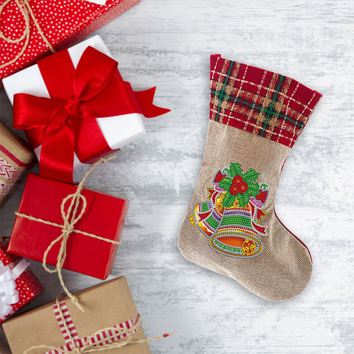 Child's hand placing a diamond onto the Christmas stocking, showcasing the easy DIY craft