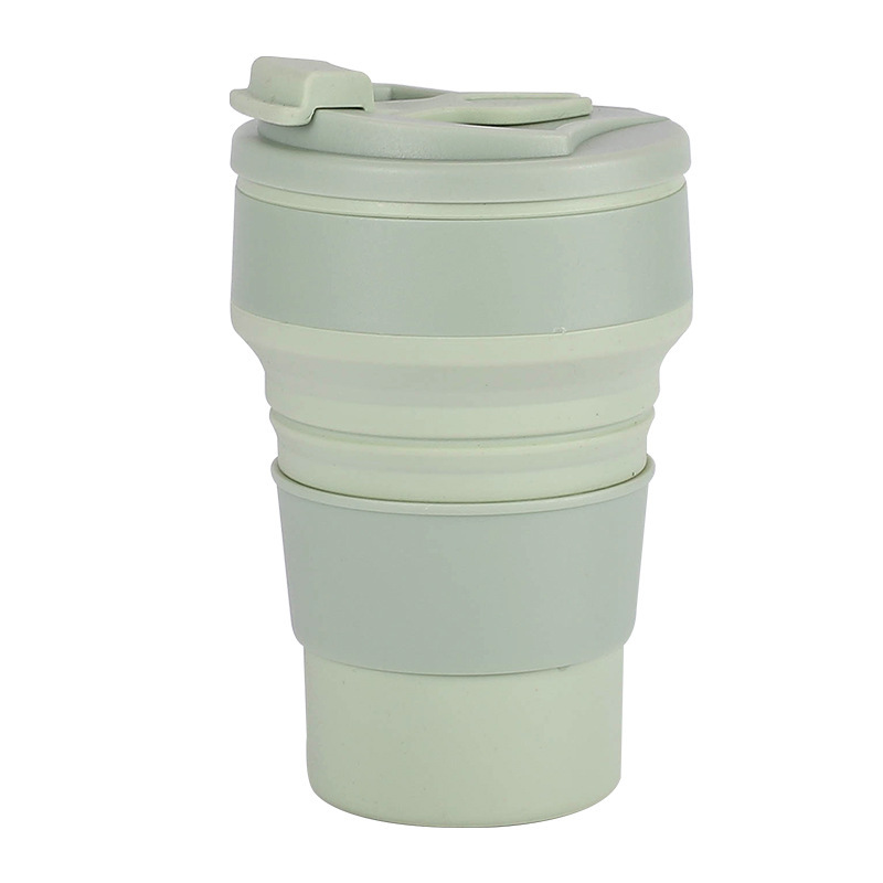 Collapsible silicone drinkware, gray, on a hiking trail, emphasizing portability and use