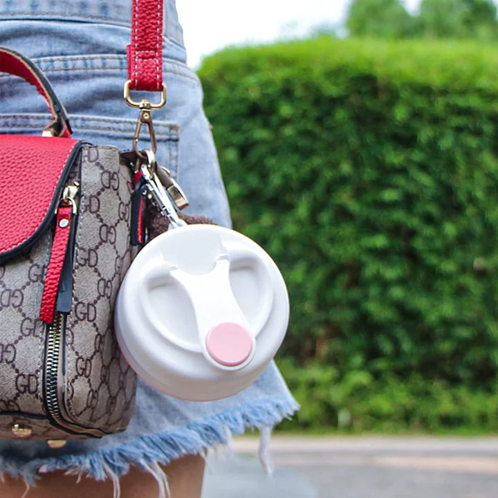 Collapsible silicone sport bottle, grey, with carabiner clip for backpack attachment