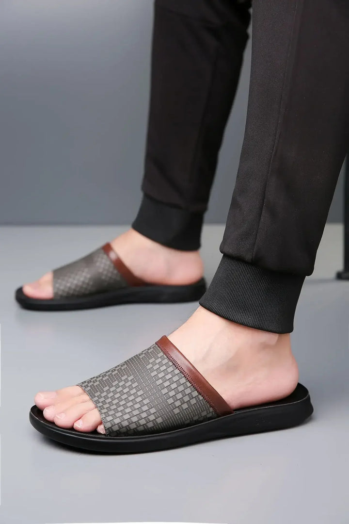 Studio shot of unisex comfort slide sandals with a textured woven strap against a clean background
