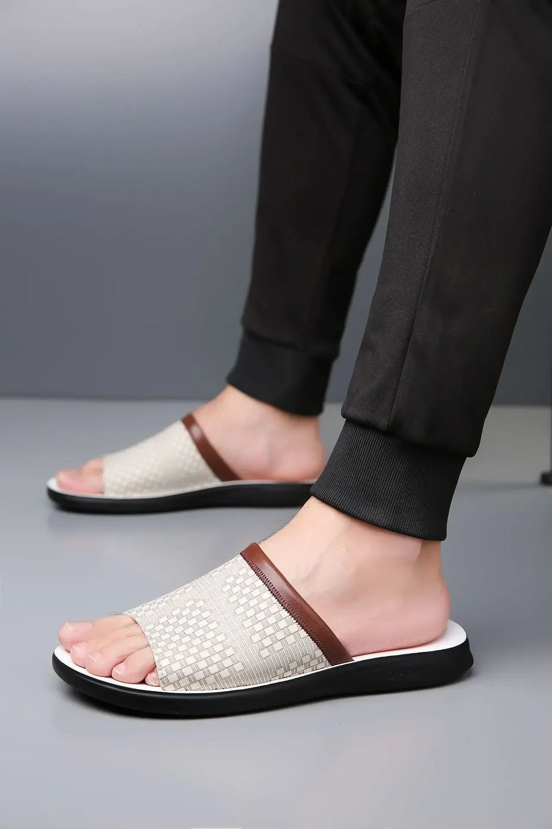 Comfort slide sandals with an intricate woven strap, designed for lightweight and airy summer wear