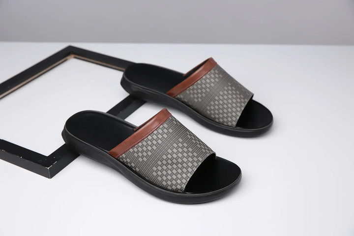 Woven strap comfort slide sandals on a beach, illustrating their use as summer footwear