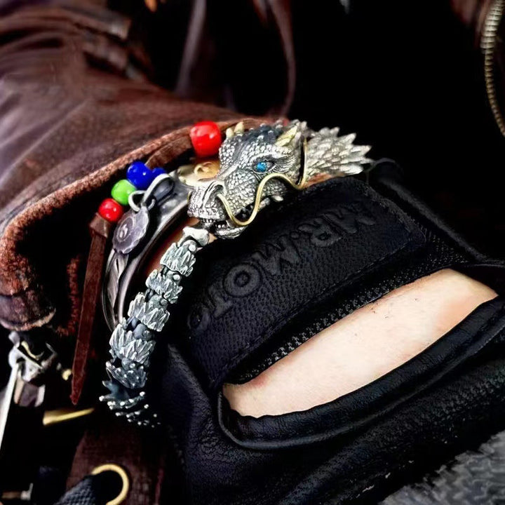 Close-up of vintage copper dragon head on a unisex chain bracelet, detailed design