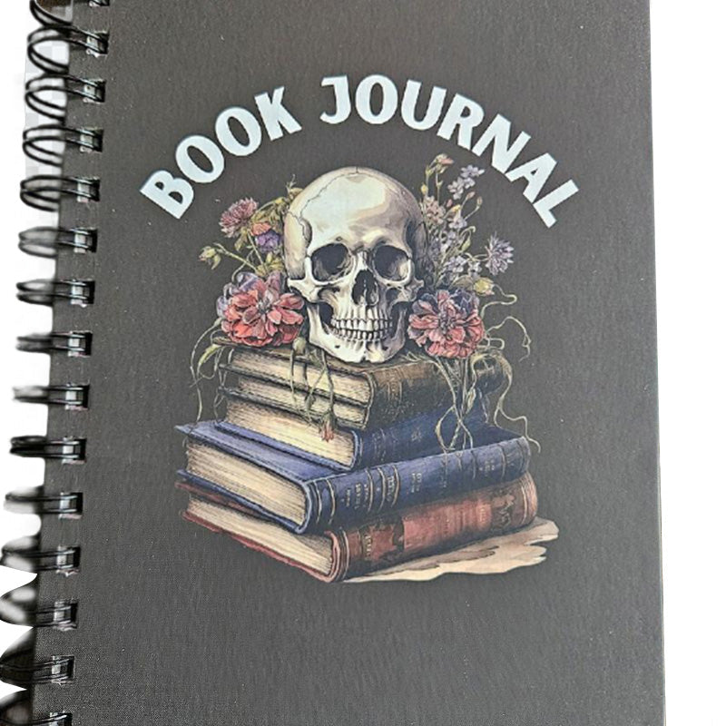 Close-up of watercolor pencils creating a colorful doodle within the pages of the reading journal.