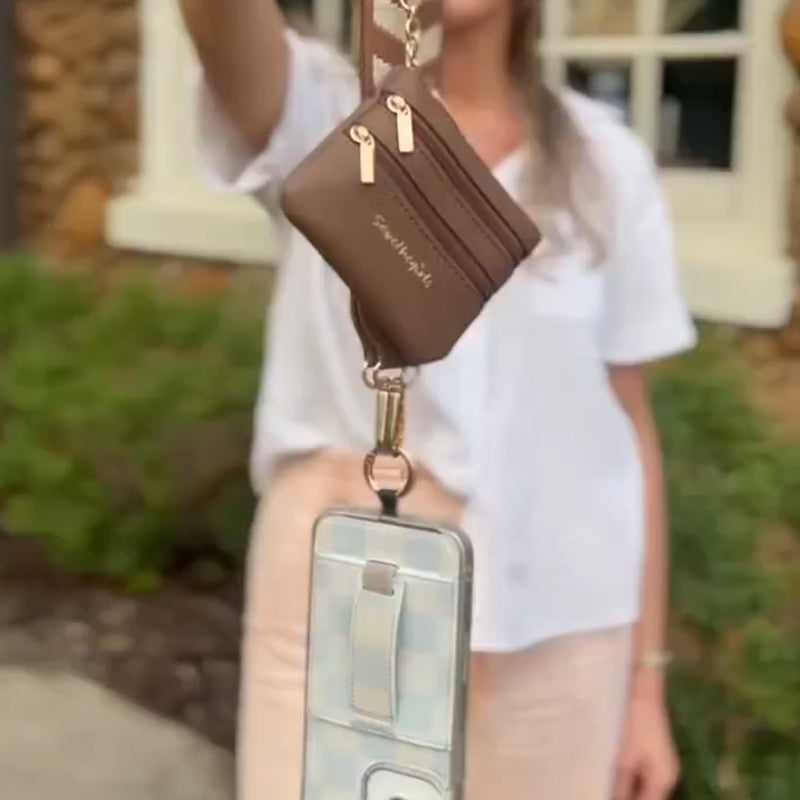 Fashion-forward black crossbody phone strap with a zipper pouch for compact everyday essentials.