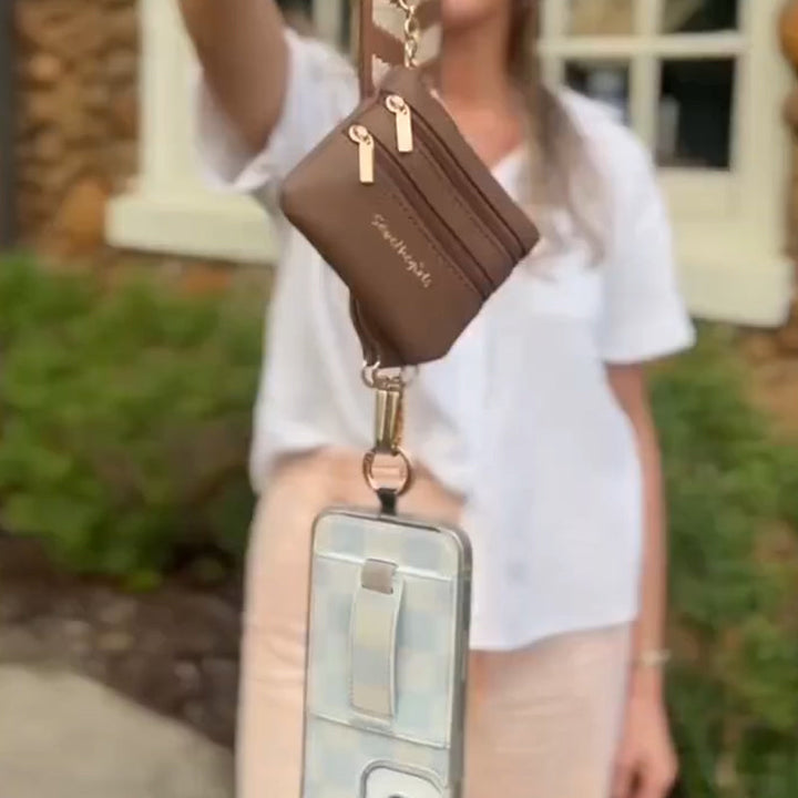 Fashion-forward black crossbody phone strap with a zipper pouch for compact everyday essentials.