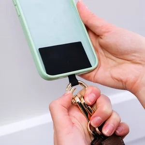 Nylon crossbody phone strap in black, featuring a practical zipper pouch for storage while on the go.