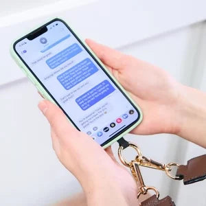 Unisex phone strap in black, designed for crossbody wear, with a built-in zipper pouch for secure items.
