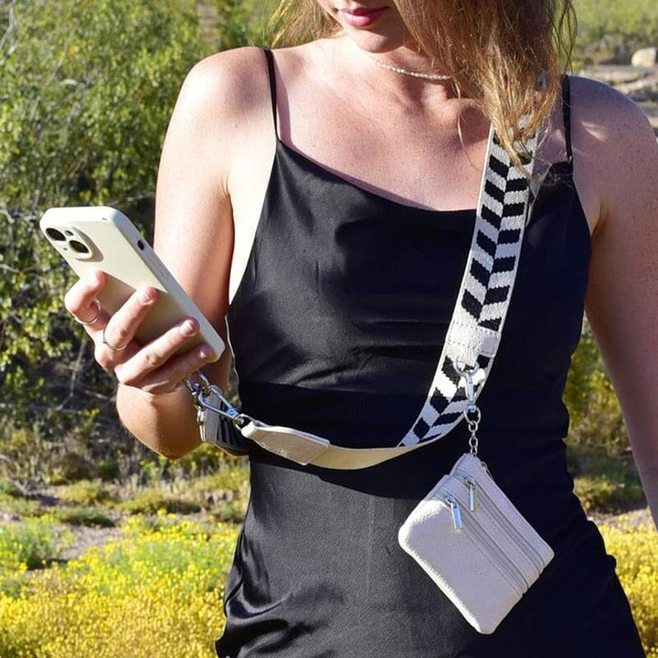 Unisex black phone strap, worn crossbody, featuring a handy zipper pouch for secure storage.