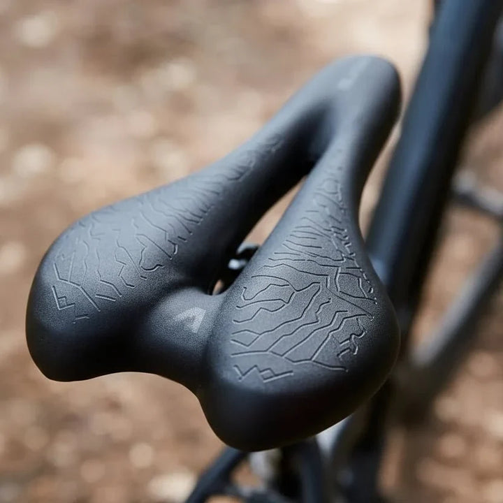 Unisex ergonomic bicycle saddle with plush memory foam for superior cycling comfort & pressure relief.