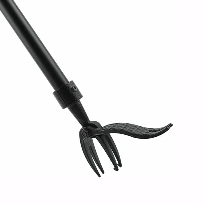 Overhead shot of the weed puller tool positioned to remove a stubborn thistle from the soil
