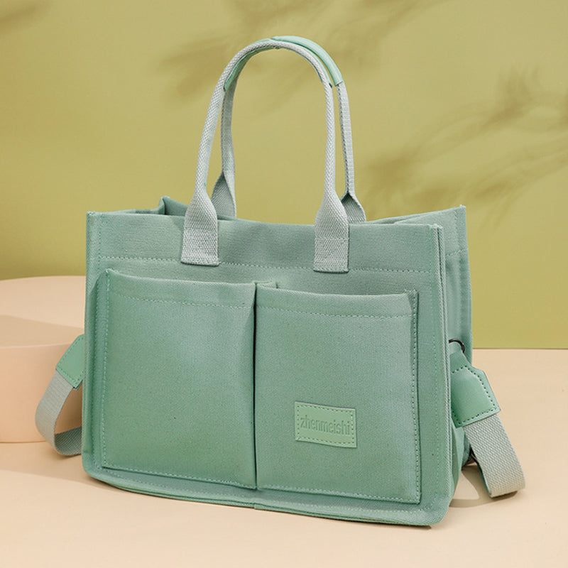 Unisex fashion canvas bag in a minimalist style, offering both functionality and aesthetic appeal.