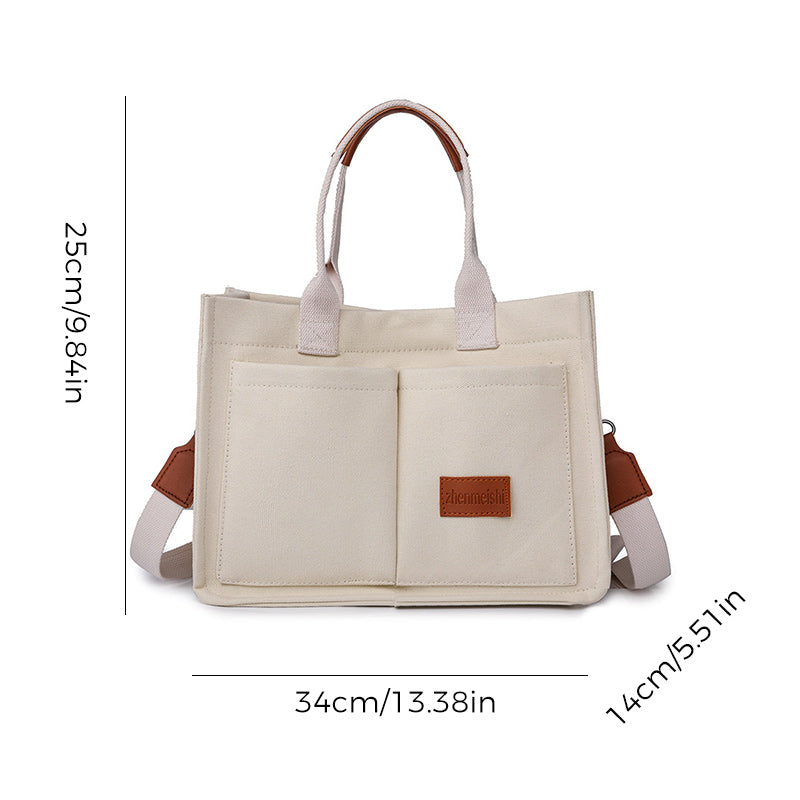 Front zipper pocket detail on a unisex canvas crossbody bag, ideal for quick access items.
