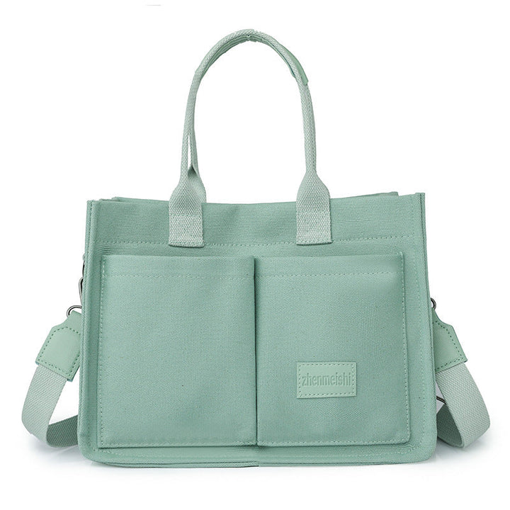 Fashionable unisex bag, a durable canvas crossbody with a secure flap closure.