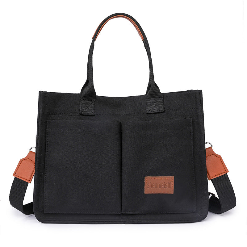 Everyday essentials fit perfectly in this unisex canvas crossbody bag, a blend of style and utility.