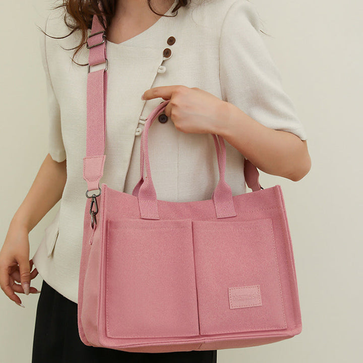 Front view of a unisex canvas crossbody bag, showcasing its simple yet chic design.