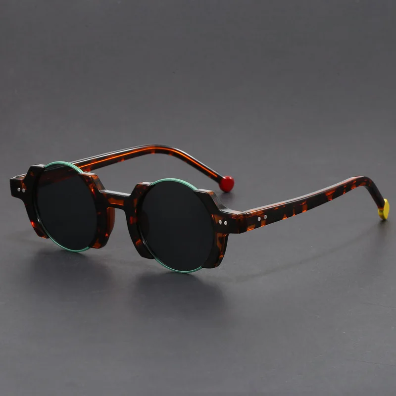 Unisex futuristic round frame sunglasses with a slight reflection, highlighting their dark, protective lenses.