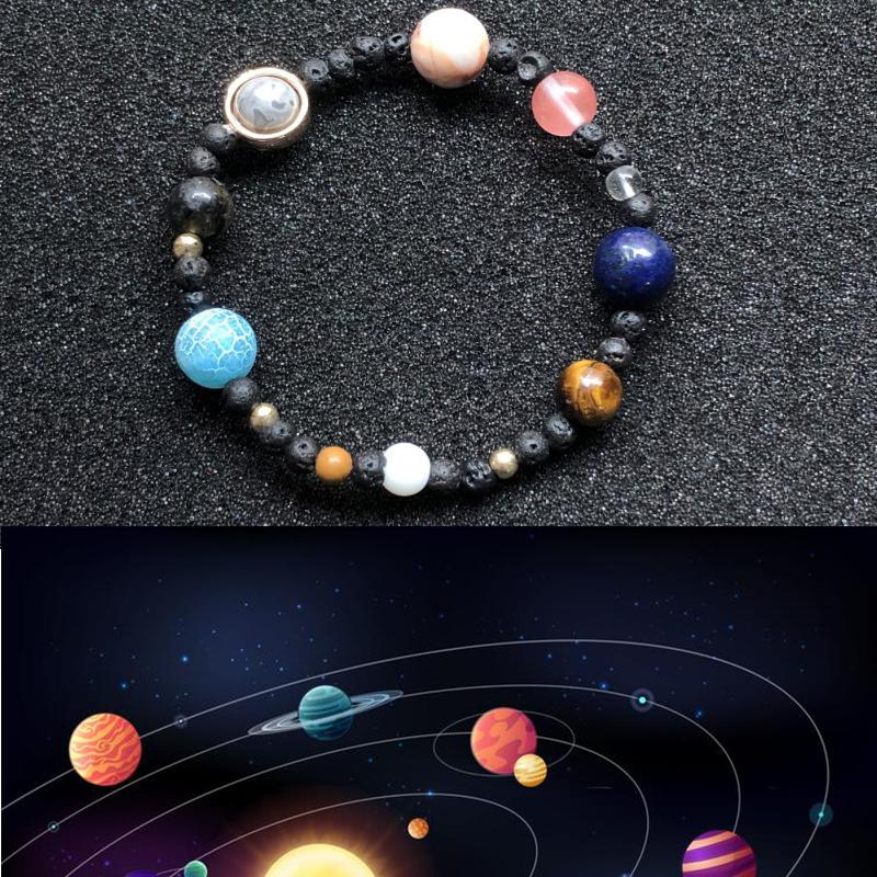 Close-up of a unisex solar system bracelet with polished natural gemstones representing planets.