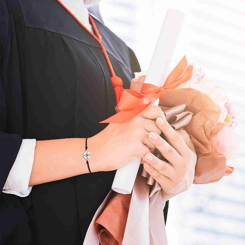Close-up of Unisex Graduation Compass Bracelet, detailed compass charm, engraved design, commemorative jewelry