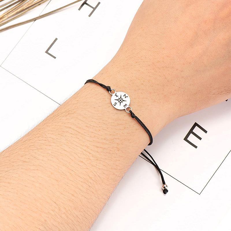 Detailed shot of compass charm on graduation bracelet, symbolizing guidance & new beginnings