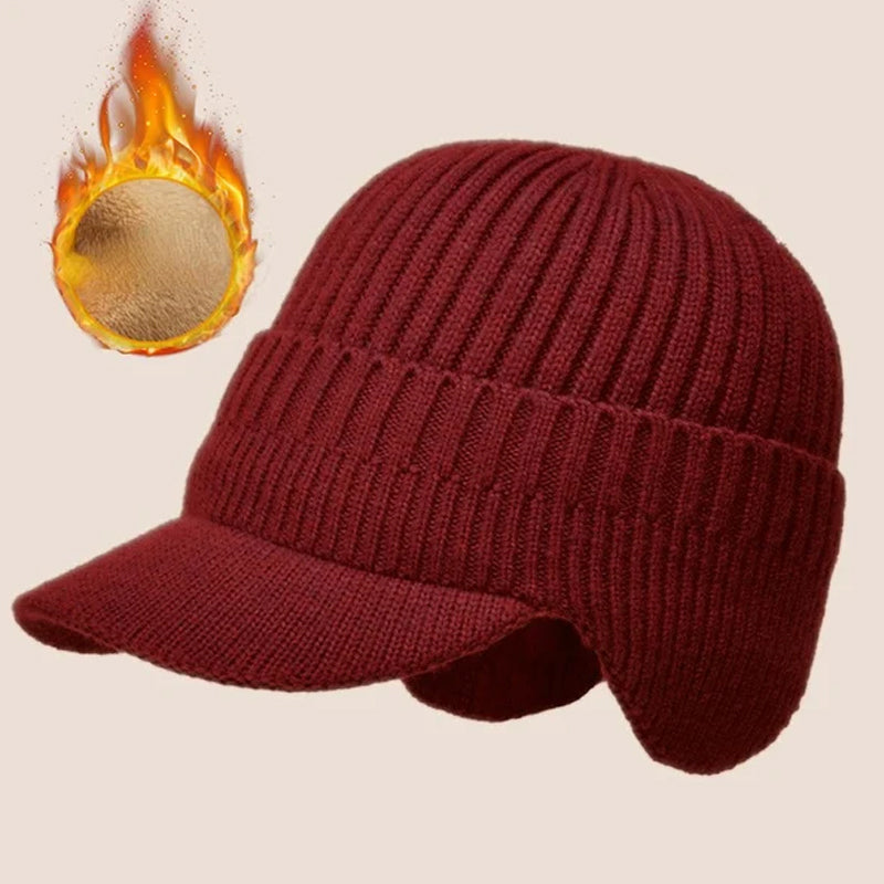 Isolated shot of a folded thick knit beanie with prominent ear protection design.