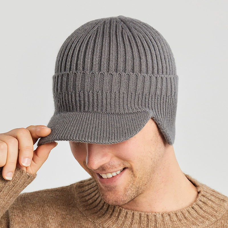 Close-up of a blue unisex knitted beanie, showcasing its thick ear protection.