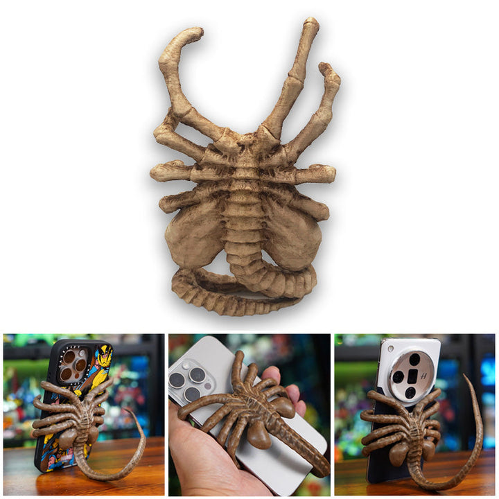 Unisex gadget: Horrible Creature Phone Stand acting as a unique office desk accessory.
