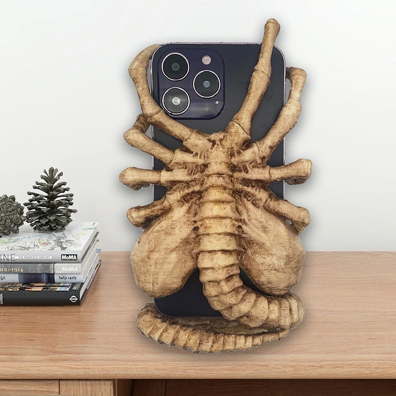 Flexible Horrible Creature Phone Holder Stand, securely displaying a mobile device.