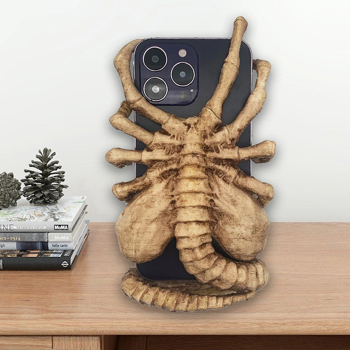 Flexible Horrible Creature Phone Holder Stand, securely displaying a mobile device.