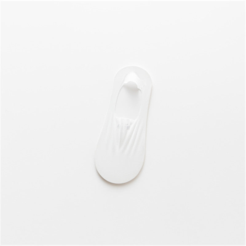 A stack of three pairs of invisible low-cut socks, emphasizing their compact size and utility