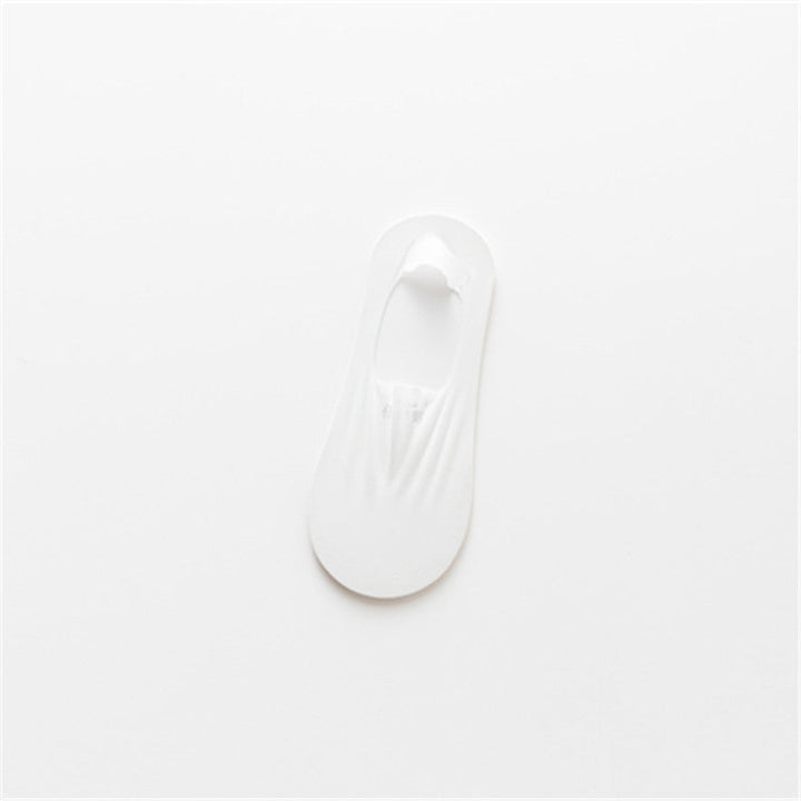 A stack of three pairs of invisible low-cut socks, emphasizing their compact size and utility