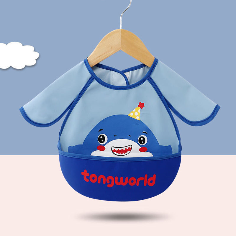 Happy toddler wearing a long sleeve waterproof bib with food catcher, enjoying a meal without making a mess