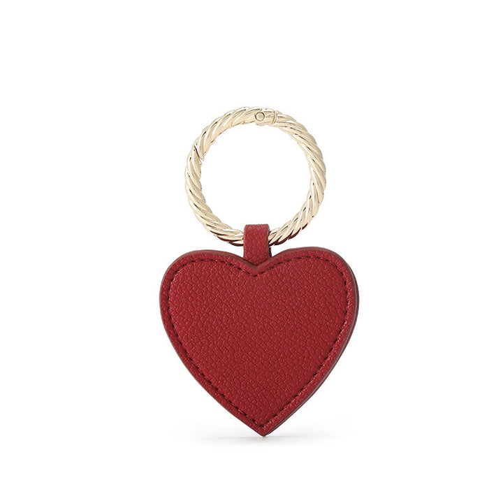 Faux leather magnetic hat clip in a vibrant red, adding a pop of color to travel gear.